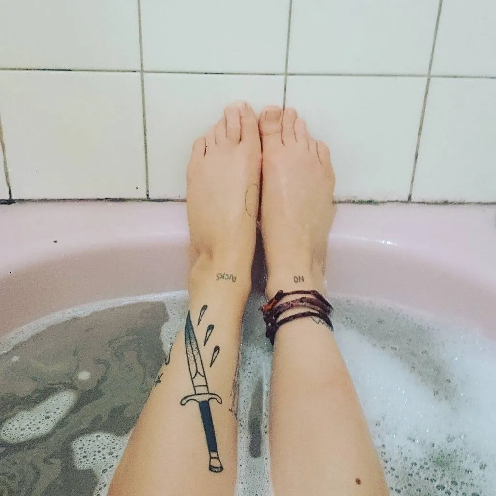 Small Blackwork Knife Tattoo on Women Leg by @skeletonroad
