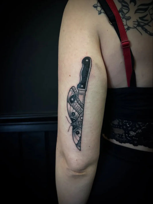 Small Blackwork Knife with Moth Tattoo on Women Arm by @tudor.tatts
