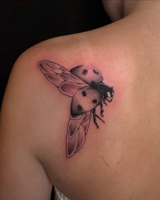 Small Blackwork Ladybug Tattoo on Women Shoulder by @withlovetattoo912