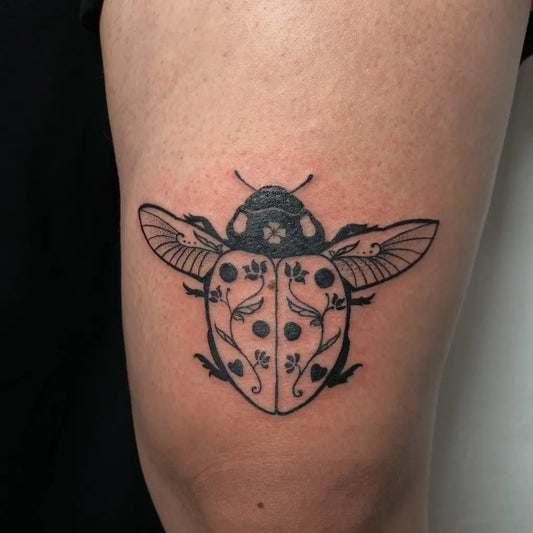 Small Blackwork Ladybug and Flowers Tattoo on Women Thigh by @itssvink
