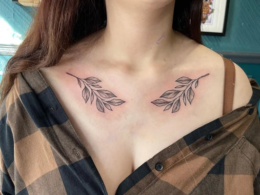 Small Blackwork Laurel Branches Tattoo on Women Collarbone by @meganfordtattoo