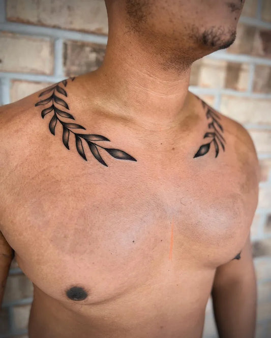 Small Blackwork Laurel Tattoo on Men Collarbone by @kyleigh.tattoo