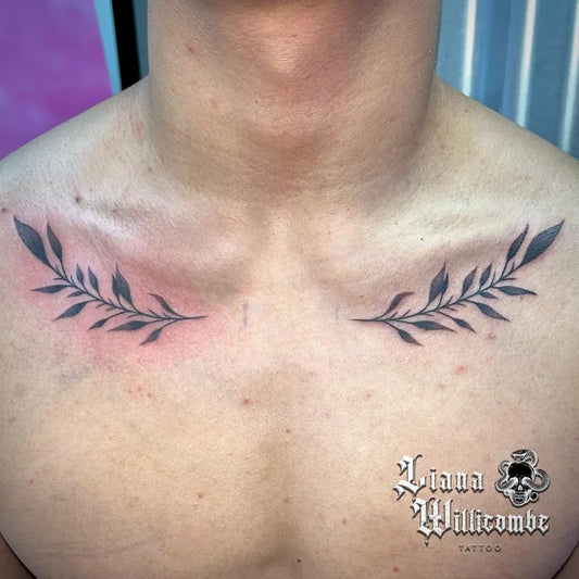 Small Blackwork Laurel Tattoo on Men Collarbone by @lianawillicombetattoo
