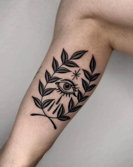 Small Blackwork Laurel Wreath Eye Tattoo on Men Arm by @maxderstecher