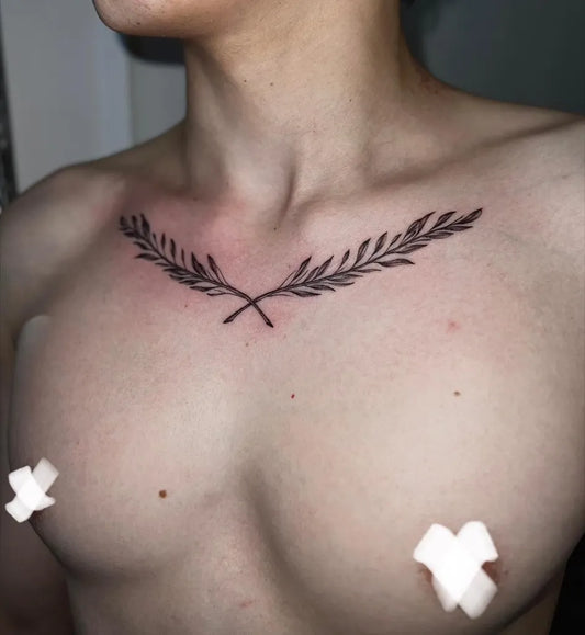 Small Blackwork Laurel Wreath Tattoo on Men Chest by @tinybreds