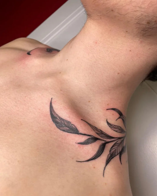 Small Blackwork Laurel Wreath Tattoo on Men Collarbone by @kojitatts