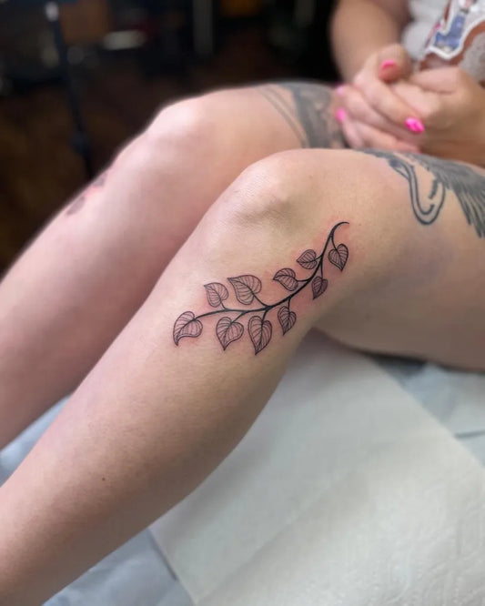Small Blackwork Leaves Tattoo on Women Knee by @kgw.tattoo