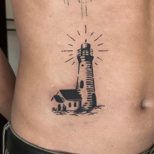 Small Blackwork Lighthouse and House Tattoo on Men Torso by @cvleb.ttt