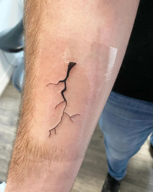Small Blackwork Lightning Bolt Tattoo on Men Arm by @seven18co
