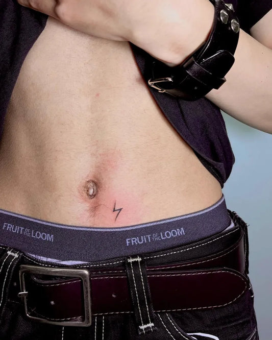 Small Blackwork Lightning Bolt Tattoo on Men Stomach by @misa.inks