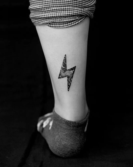 Small Blackwork Lightning Bolt Tattoo on Women Ankle by @korovles