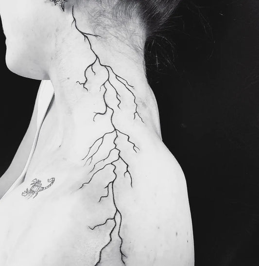 Small Blackwork Lightning Bolt Tattoo on Women Shoulder by @mynosetattoo