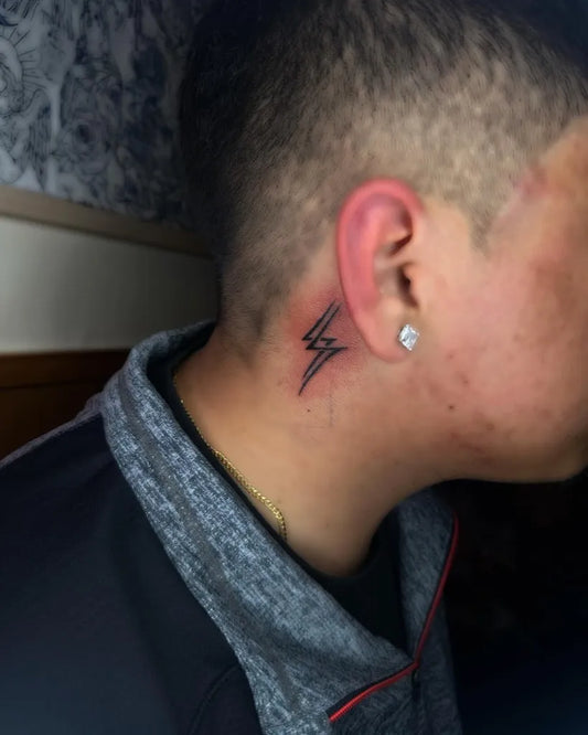 Small Blackwork Lightning Bolts Tattoo on Men Behind the Ear by @yahfavtats