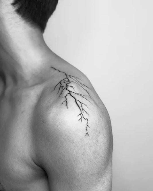 Small Blackwork Lightning Tattoo on Men Shoulder by @halil_asuraci_tattooart