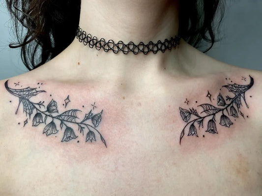 Small Blackwork Lily of the Valley and Stars on Women Collarbone Tattoo by @zars.inks