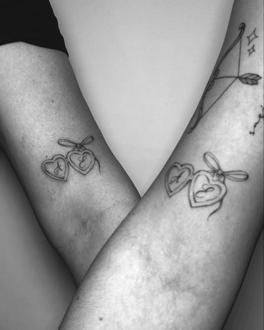 Small Blackwork Linked Hearts with Bows Family Tattoo on Women Arms by @wilku_tattoo