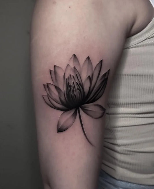 Small Blackwork Lotus Flower on Women Arm Tattoo by @kittisak_tattoo