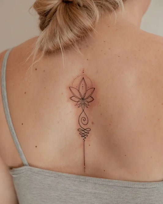Small Blackwork Lotus Flower on Women Back Tattoo by @stefxink