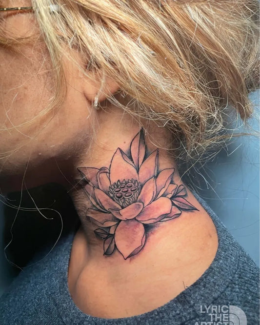 Small Blackwork Lotus Flower on Women Neck Tattoo by @ironpalmtattoos