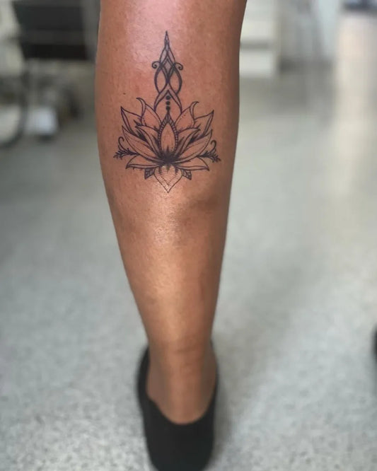 Small Blackwork Lotus Flower on Women Thigh Tattoo by @rochellebatespmua