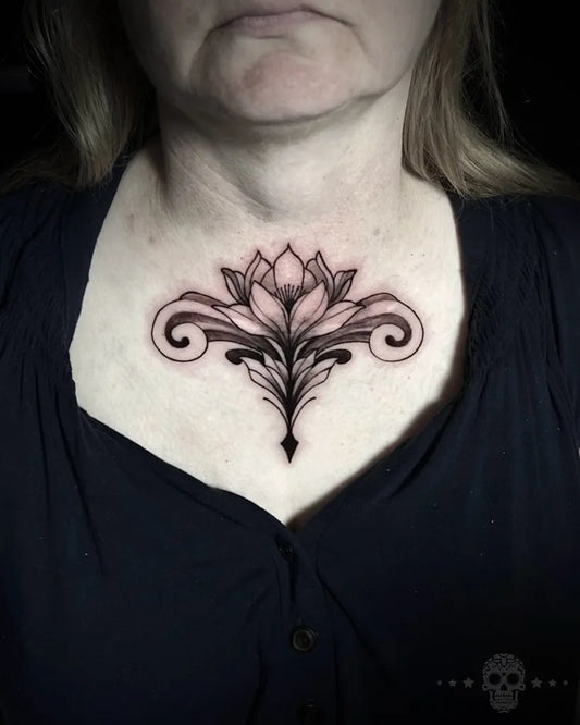 Small Blackwork Lotus on Women Chest Tattoo by @crafttattoomaidstone