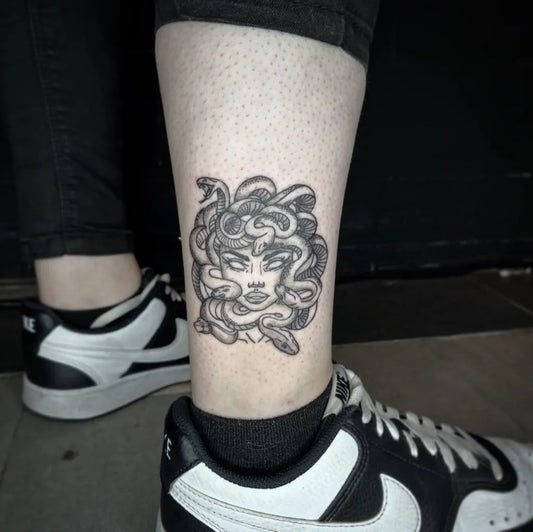 Small Blackwork Medusa on Women Leg Tattoo by @petite.kuromi.ink