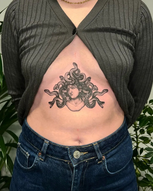 Small Blackwork Medusa on Women Sternum Tattoo by @ashleytysontattoo