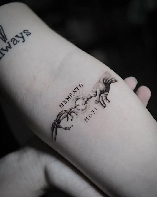 Small Blackwork Memento Mori Hands on Women Forearm Tattoo by @theartoftattooingofficial