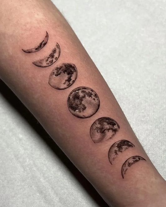 Small Blackwork Moon Phases Tattoo on Women Arm by @valentinasin_tattoo