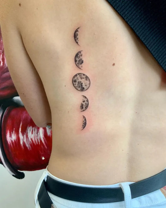 Small Blackwork Moon Phases Tattoo on Women Back by @osidax_ink