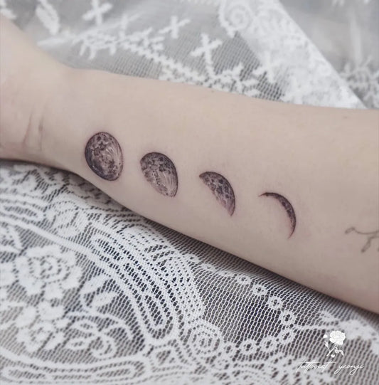 Small Blackwork Moon Phases Tattoo on Women Wrist by @yeonji_tattooer
