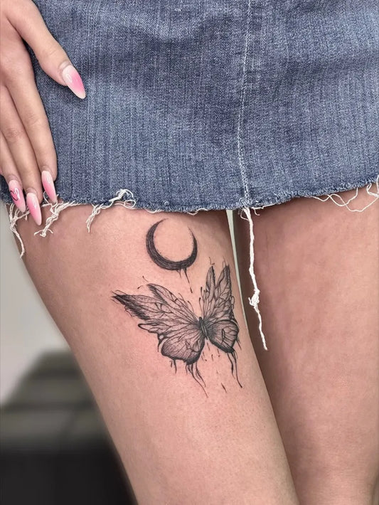 Small Blackwork Moon and Butterfly Tattoo on Women Thigh by @tattoo.ghazale2