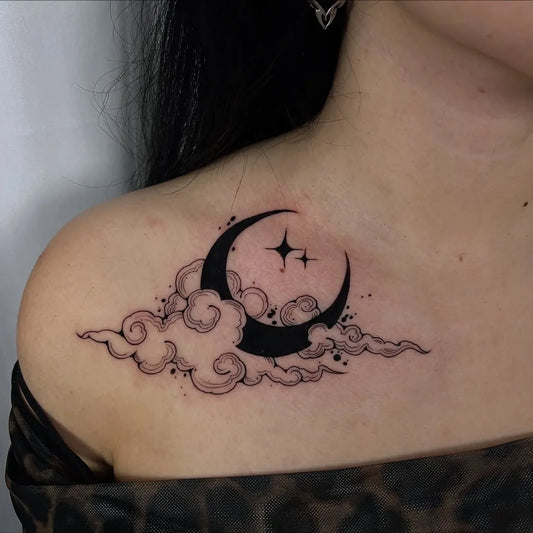 Small Blackwork Moon and Clouds Tattoo on Women Shoulder by @xen.inkz