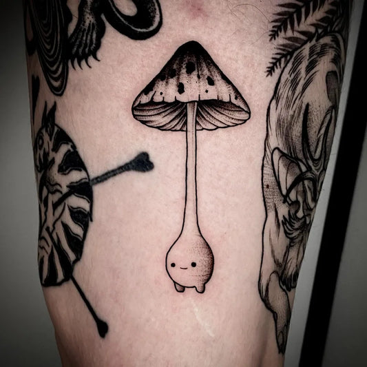 Small Blackwork Mushroom on Men Thigh Tattoo by @juny_todd