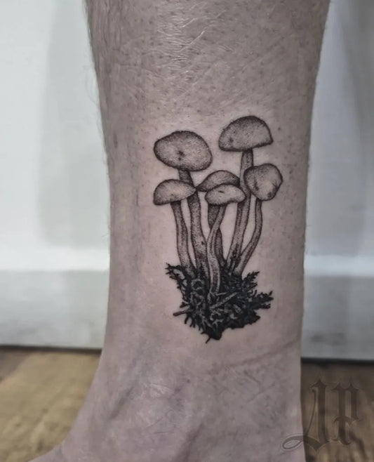 Small Blackwork Mushrooms on Men Leg Tattoo by @jack_padointattoo