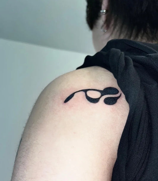 Small Blackwork Musical Note Tattoo on Women Shoulder by @pokey.kim