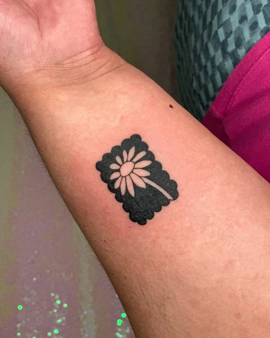 Small Blackwork Negative Space Daisy Tattoo on Women Wrist by @minjiyang_tattooer