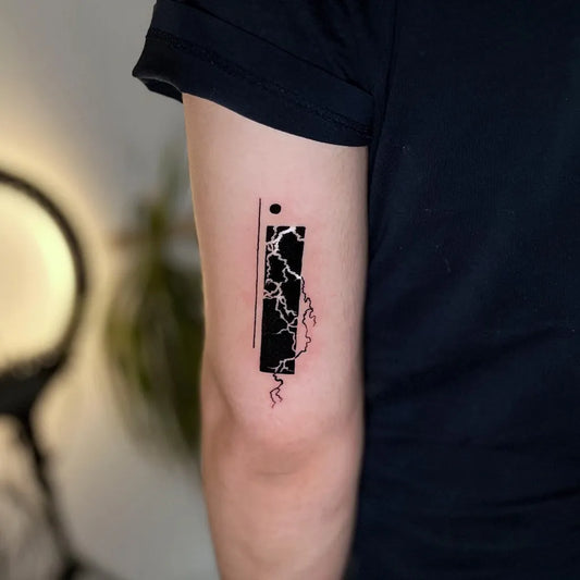 Small Blackwork Negative Space Lightning Bolt Tattoo on Men Arm by @onurzeytin.ink