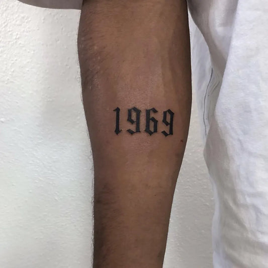 Small Blackwork Numbers Tattoo on Men Arm by @room26_reutlingen