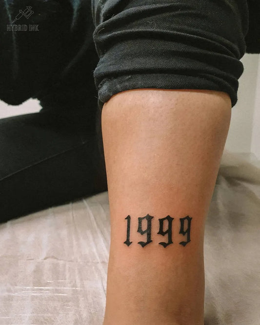 Small Blackwork Numbers Tattoo on Women Leg by @hybridink.helsinki