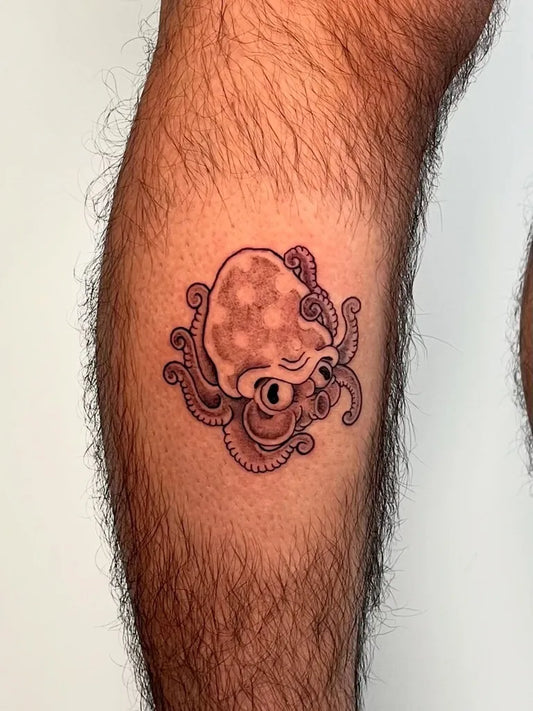 Small Blackwork Octopus Tattoo on Men Thigh by @jordanktattoo