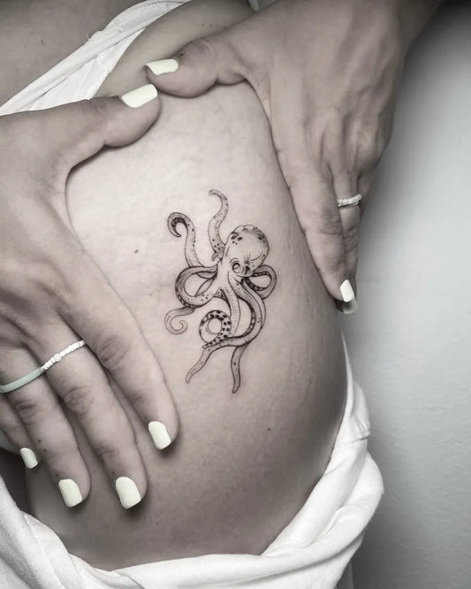 Small Blackwork Octopus Tattoo on Women Hip by @worldofinkibiza