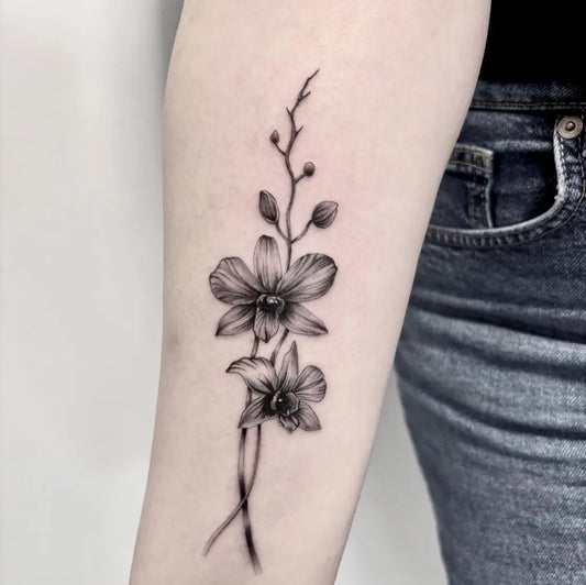 Small Blackwork Orchid Flowers Tattoo on Women Arm by @angryspirit_tattoo
