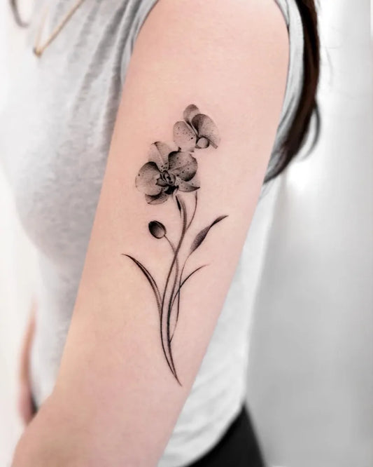 Small Blackwork Orchid Tattoo on Women Arm by @mukyeon_tattoo