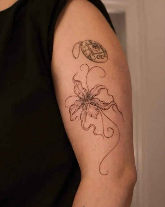 Small Blackwork Orchid Tattoo on Women Upper Arm by @eternalartistryink