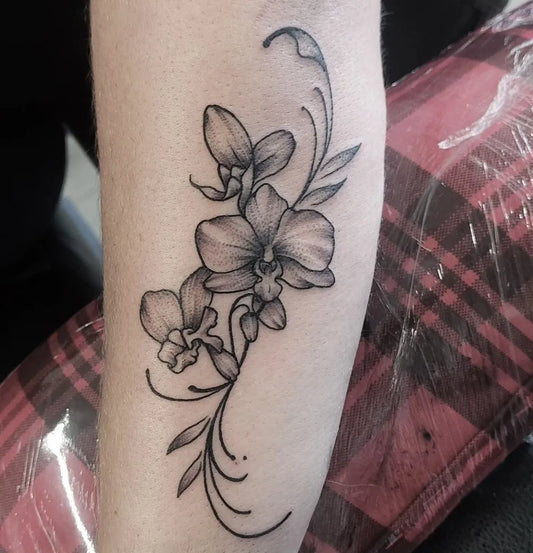Small Blackwork Orchid and Vines Tattoo on Women Arm by @star_ink_tattoo