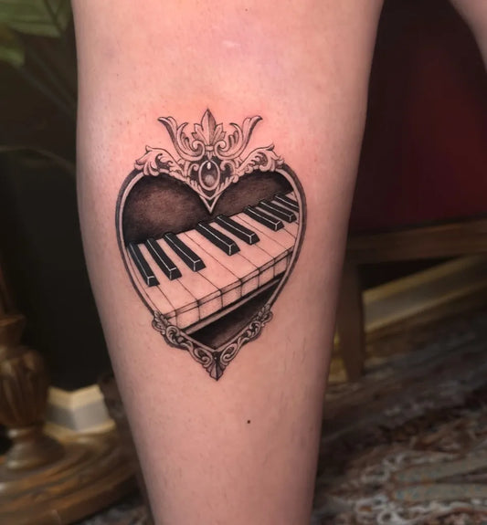 Small Blackwork Ornate Heart with Piano Keys Music Tattoo on Women Thigh by @_namantotattoo_