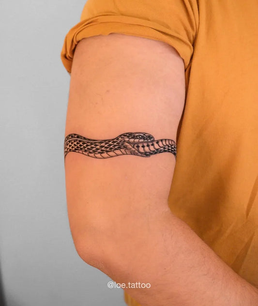 Small Blackwork Ouroboros Tattoo on Men Arm by @loe.tattoo