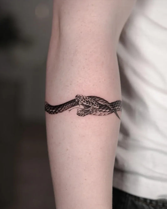 Small Blackwork Ouroboros Tattoo on Men Arm by @willfinchdesign
