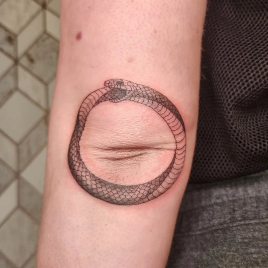 Small Blackwork Ouroboros Tattoo on Women Arm by @kattystrophic